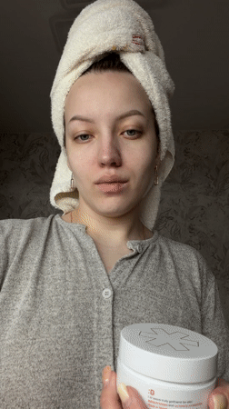 Woman applies eye patches during morning skincare routine in Russia