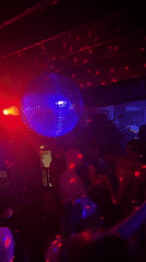 Disco ball spins over dancers at Kuta nightclub