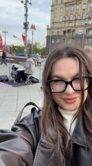 Woman documents Moscow street scenes during afternoon outing