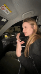 Woman makes hand gestures in passenger seat, Budva Montenegro