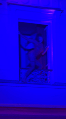 Woman dances on illuminated Parisian balcony Thursday evening