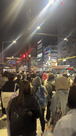 Pedestrians cross busy crosswalk in Goyang-si, South Korea