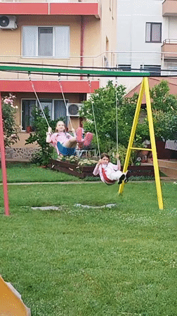 Kids playing outside in a Bucharest backyard on a summer afternoon.