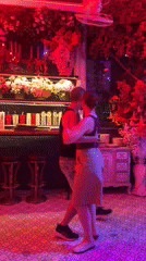 Couple dances in colorfully lit Pattaya bar venue