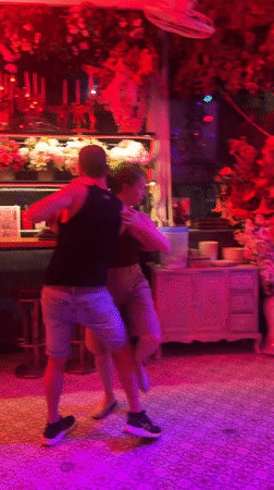 Couple dances in colorfully lit Pattaya bar venue