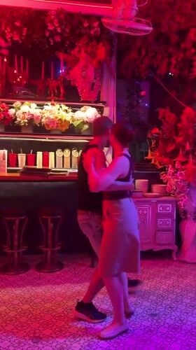 Couple dances in colorfully lit Pattaya bar venue