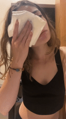 Woman dabbing face with towel appears sad in Mexico