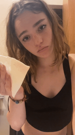 Woman dabbing face with towel appears sad in Mexico