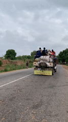 Truck transports passengers and cargo on damaged road in Nigeria