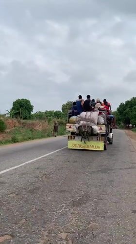 Truck transports passengers and cargo on damaged road in Nigeria