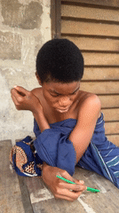 Quiet outdoor moment in Badagry, wrapped in blue fabric