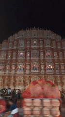Nighttime crowds gather at illuminated Hawa Mahal in Jaipur