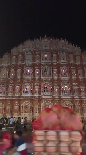 Nighttime crowds gather at illuminated Hawa Mahal in Jaipur