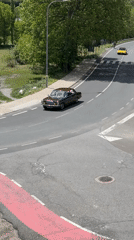 Mixed traffic navigates winding intersection in Benasque, Spain