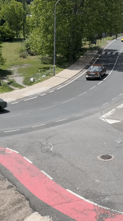 Mixed traffic navigates winding intersection in Benasque, Spain