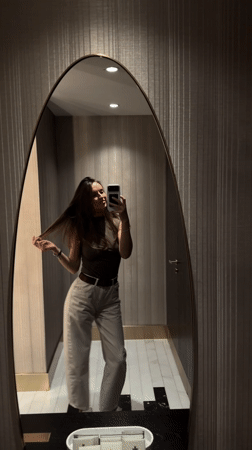 Woman takes mirror selfies in Budva, Montenegro