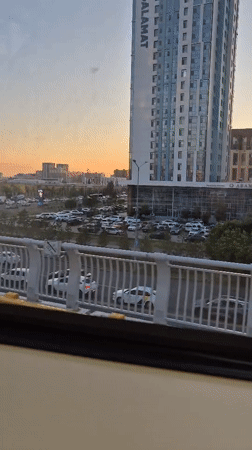 Riding Astana's elevated light rail through a modern city skyline