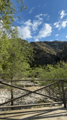 Observer captures landscape view of riverbed from elevated position