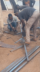 Workers conduct outdoor metal welding operations in Akwanga, Nigeria