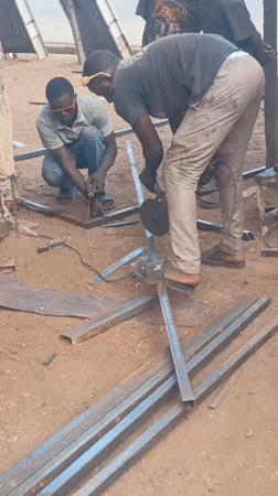 Workers conduct outdoor metal welding operations in Akwanga, Nigeria