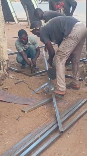 Workers conduct outdoor metal welding operations in Akwanga, Nigeria
