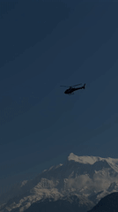 Helicopter spotted flying near snow-covered mountains in Pokhara