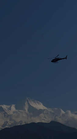 Helicopter spotted flying near snow-covered mountains in Pokhara