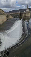 Water flows over concrete dam in Bulgarian village