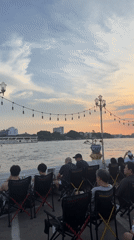 Casual street scenes and riverside gathering documented in Bangkok