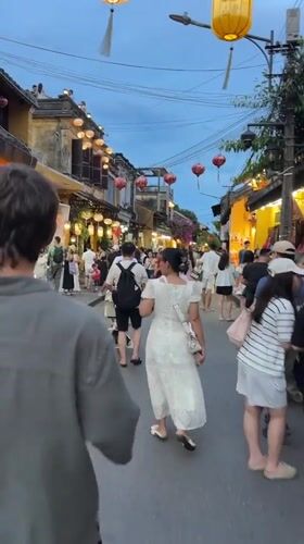 Hoi An's lantern-lit streets buzzing with evening street food crowds
