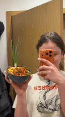 Woman takes food selfie with colorful bowl in Varna
