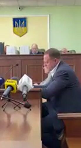 Court proceedings with handcuffed defendant documented in Kyiv