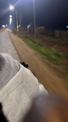 Night bicycle ride captured on streetlit road in Bukuru
