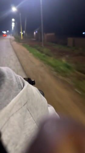 Night bicycle ride captured on streetlit road in Bukuru
