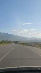 Vehicle travels curved two-lane road near Marino Pole, Bulgaria