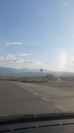 Vehicle travels curved two-lane road near Marino Pole, Bulgaria