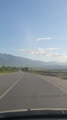 Vehicle travels curved two-lane road near Marino Pole, Bulgaria