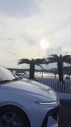 Vehicle travels scenic waterfront road in Bac Nha Trang