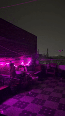 Evening hookah gathering documented at LED-lit Delhi patio