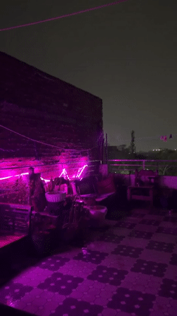 Evening hookah gathering documented at LED-lit Delhi patio