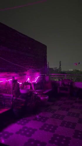 Evening hookah gathering documented at LED-lit Delhi patio
