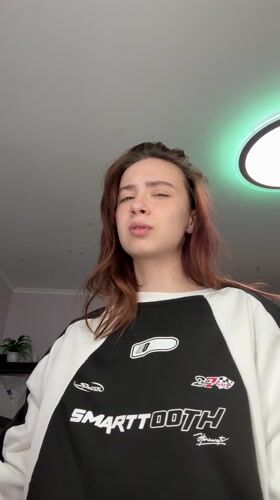 Woman takes mirror selfie in Russian apartment