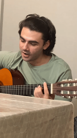 Acoustic guitar performance captured in Ruse home setting