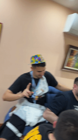 Four men celebrate with cheese and drinks in Bulgaria
