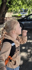 Young girl coughing outdoors in Montenegro morning