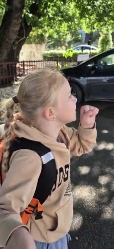 Young girl coughing outdoors in Montenegro morning