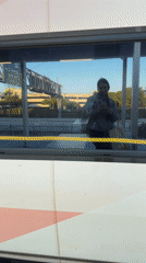 Late night train passenger travels through Aventura using phone