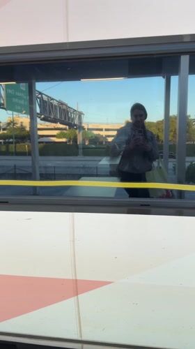 Late night train passenger travels through Aventura using phone