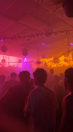 Inside a hazy Brooklyn venue, disco balls and exit signs