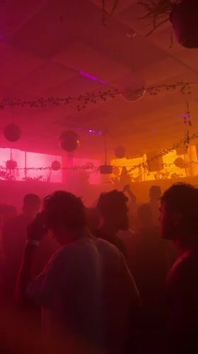 Inside a hazy Brooklyn venue, disco balls and exit signs